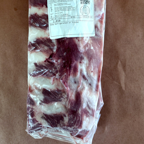 Pasture-raised baby back rib rack, vacuum sealed and frozen