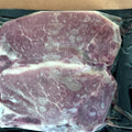 Two bone-in pasture-raised pork loin chops, vacuum sealed